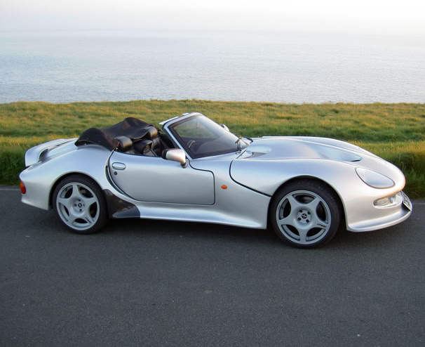 Collection of vintage Polaroid photos clipped to a wooden wall indoors.