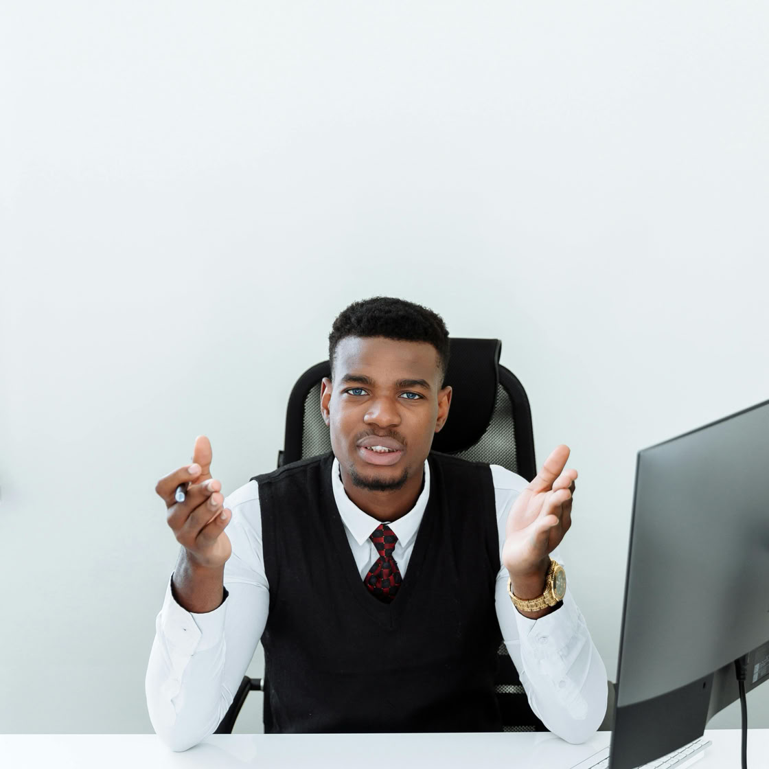 Confident African American businessman having a discussion at his office desk.